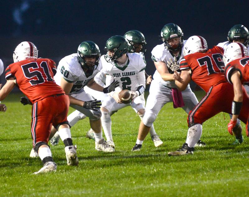 West Carroll quarterback Raef Schintgen looks to hand the ball off during Friday, Sept. 22, 2023 action against the Cardinals at Forreston High School.