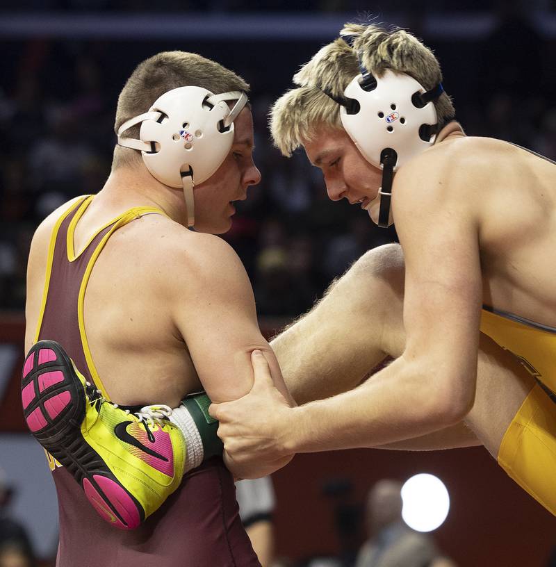 Richmond-Burton’s Blake Livdahl (left) controls the leg of Lena-Winslow’s Eli Larson in the 175 pound weight class of the 1A state individual wrestling finals Saturday, Feb. 22, 2025, at State Farm Center in Champaign.