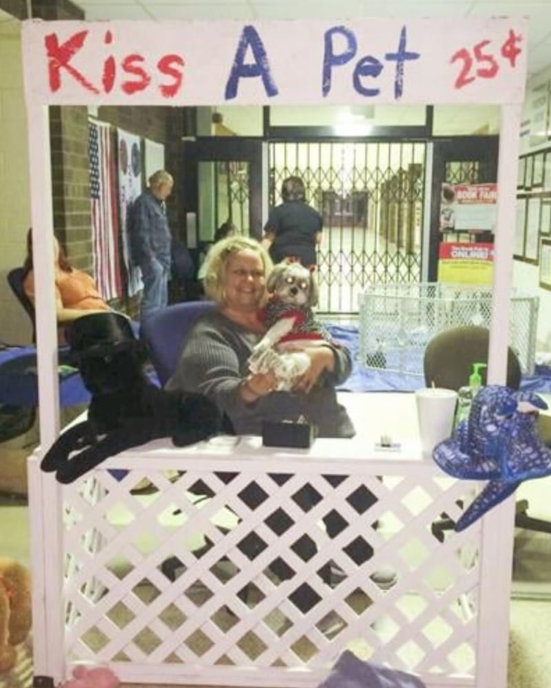 Rochelle Langlois, a 30-year paraprofessional in the Bourbonnais School District, works a fundraiser booth during a school event. Langlois, 58, is battling complications from stage four brain cancer.