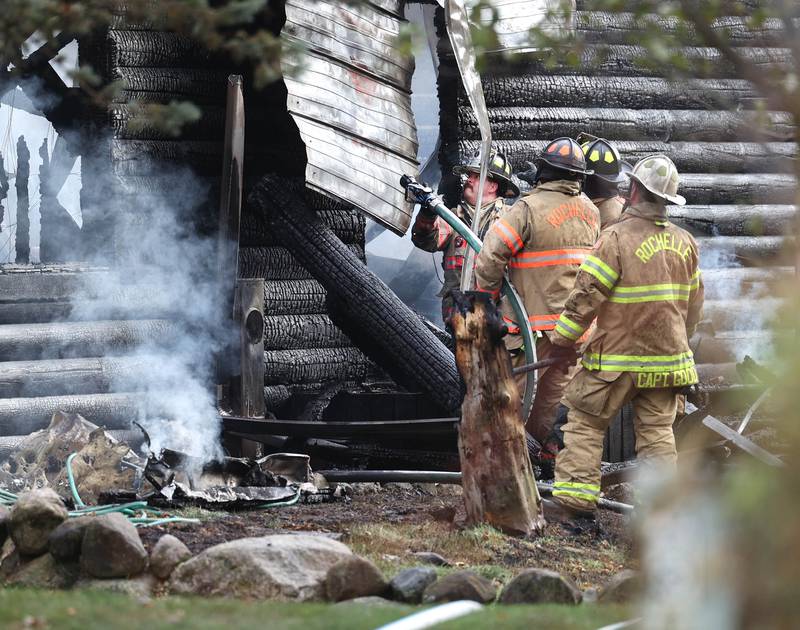 Rochelle firefighters prepare to put water on a house that was destroyed by fire Thursday, Nov. 13, 2025, near Shabbona Grove Road in Shabbona. Several local departments responded to the general alarm structure fire.