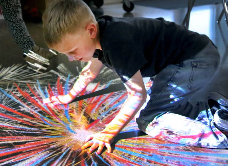 Jack Sanderson, 6, from Kirkland, has some fun with an interactive projected image Wednesday, Nov. 6, 2024, during a grand opening of the Kishwaukee Special Recreation Association’s Sensory Room at the Sycamore Park District Community Center.