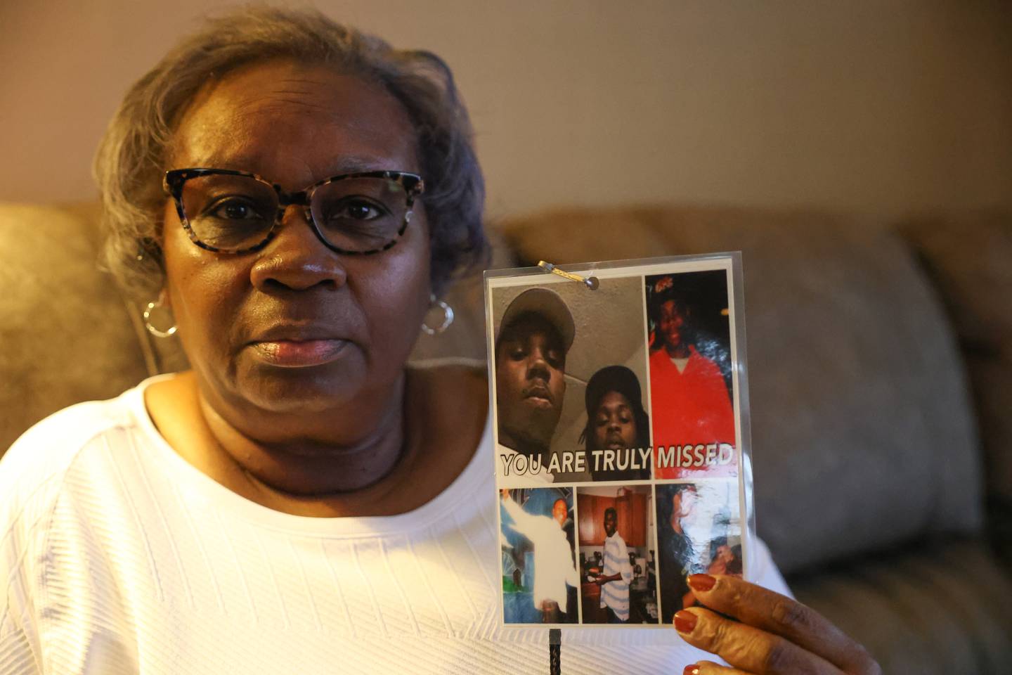 Jamille Kent holds a photo of her son Terrance Rankins, top left, and his friend Eric Glover Jr. Jan. 10, 2023 marked the 10th anniversary of the grisly Joliet murders of Terrance Rankins and Eric Glover Jr.,