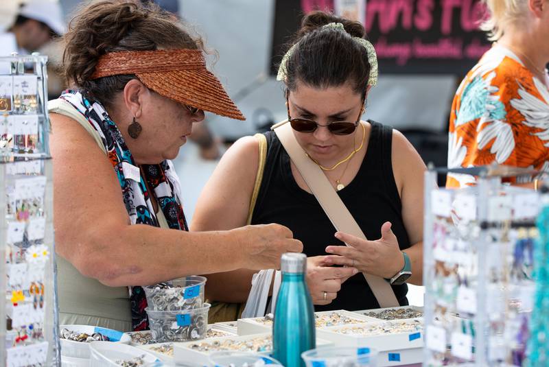 Vyara Georgieva, right, and Galina Moneva look at rings during Make Music Wheaton and the Wheaton French Market in The Wheaton French Market Plaza on Saturday, June 21, 2025.