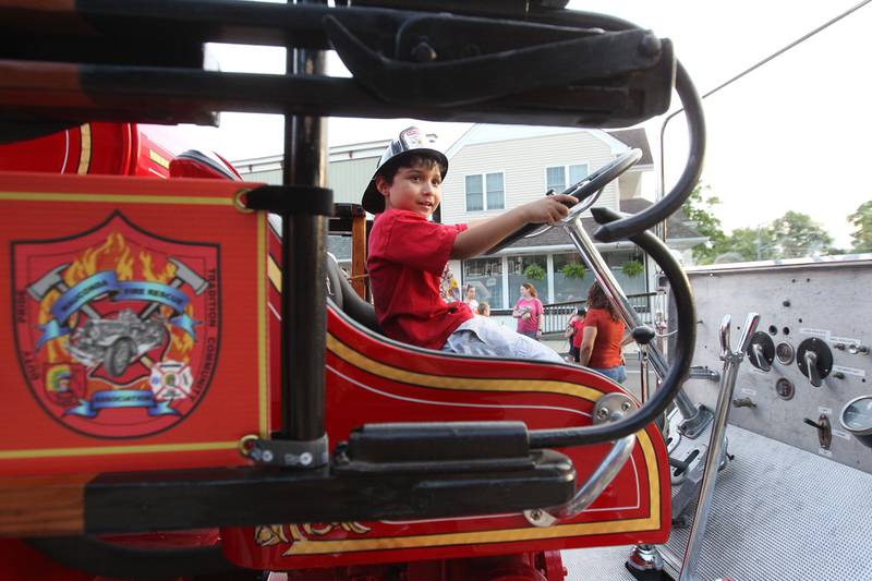 Drake Foderaro, 11, of Wauconda sits in "Old Betsy," Wauconda Fire Department's 1931 Pirsch fire engine during National Night Out on Main Street on Tuesday, August 1st in Wauconda.  
Photo by Candace H. Johnson for Shaw Local News Network.
