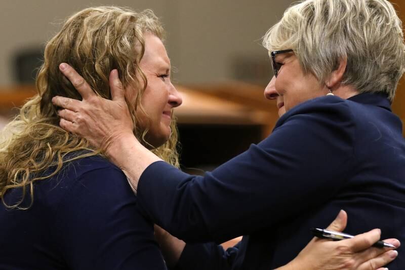 Bethany Austin, left, hugs friend Deirdre Reishus after hearing her sentencing in court with Judge Michael Coppedge at the Michael J. Sullivan Judicial Center on Thursday, June 24, 2021 in Woodstock. Austin was previously found guilty and sentenced Thursday to 12 months of conditional release with 100 hours of community service, a $250 fine, and a $100 contribution to Crime Stoppers in addition to court costs.