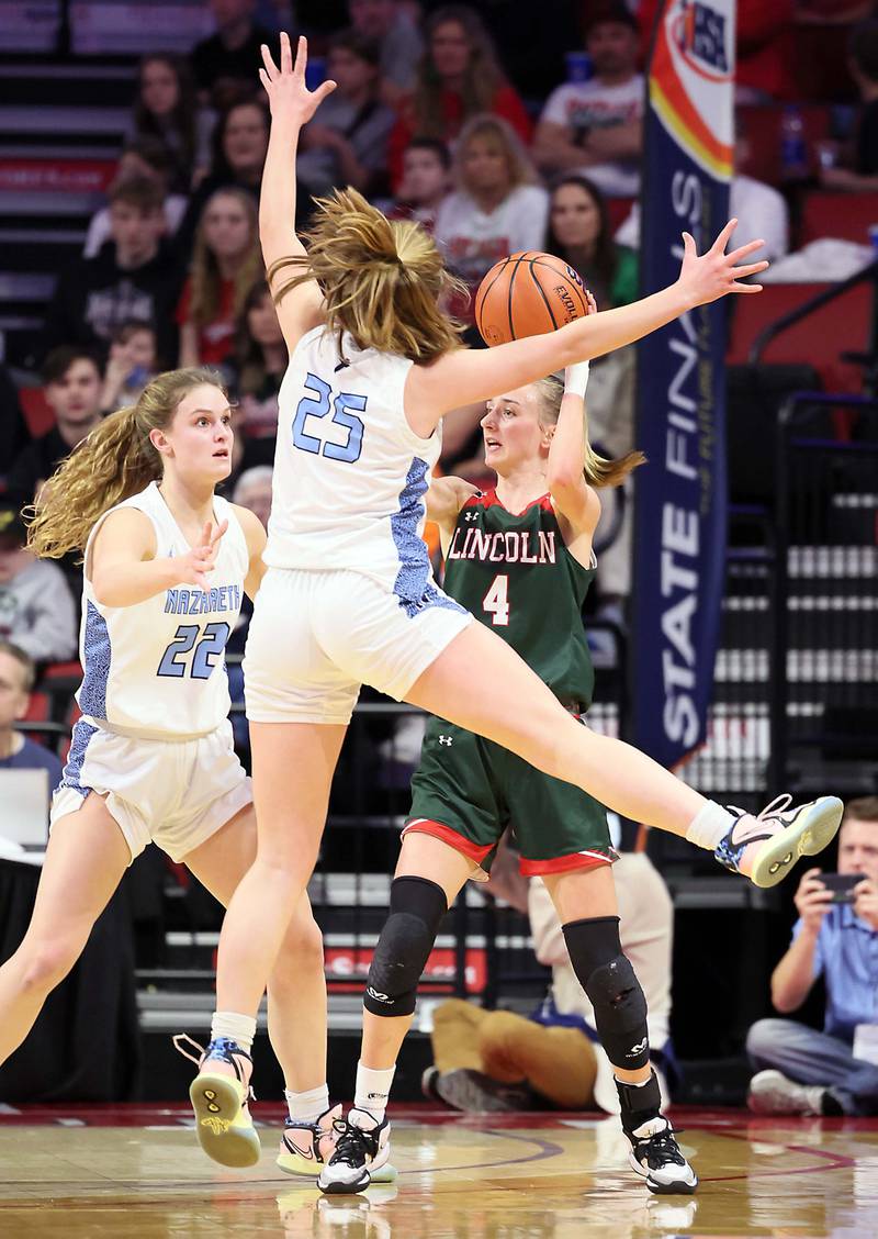Nazareth Academy's Grace Carstensen (22) and Amalia Dray (25) lock down Lincoln's Becca Heitzig (4) during the IHSA Class 3A girls basketball championship game at the CEFCU Arena on the campus of Illinois State University Saturday March 4, 2023 in Normal.