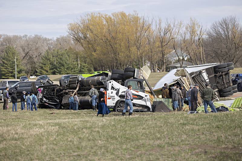 First responders and neighbors work at an accident scene in rural Whiteside County Thursday, March 28, 2024.