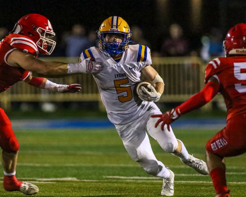 Lyon's Danny Caroll (5) throws a stiff arm during football game between Hinsdale Central at Lyons.  Sept 8, 2023.