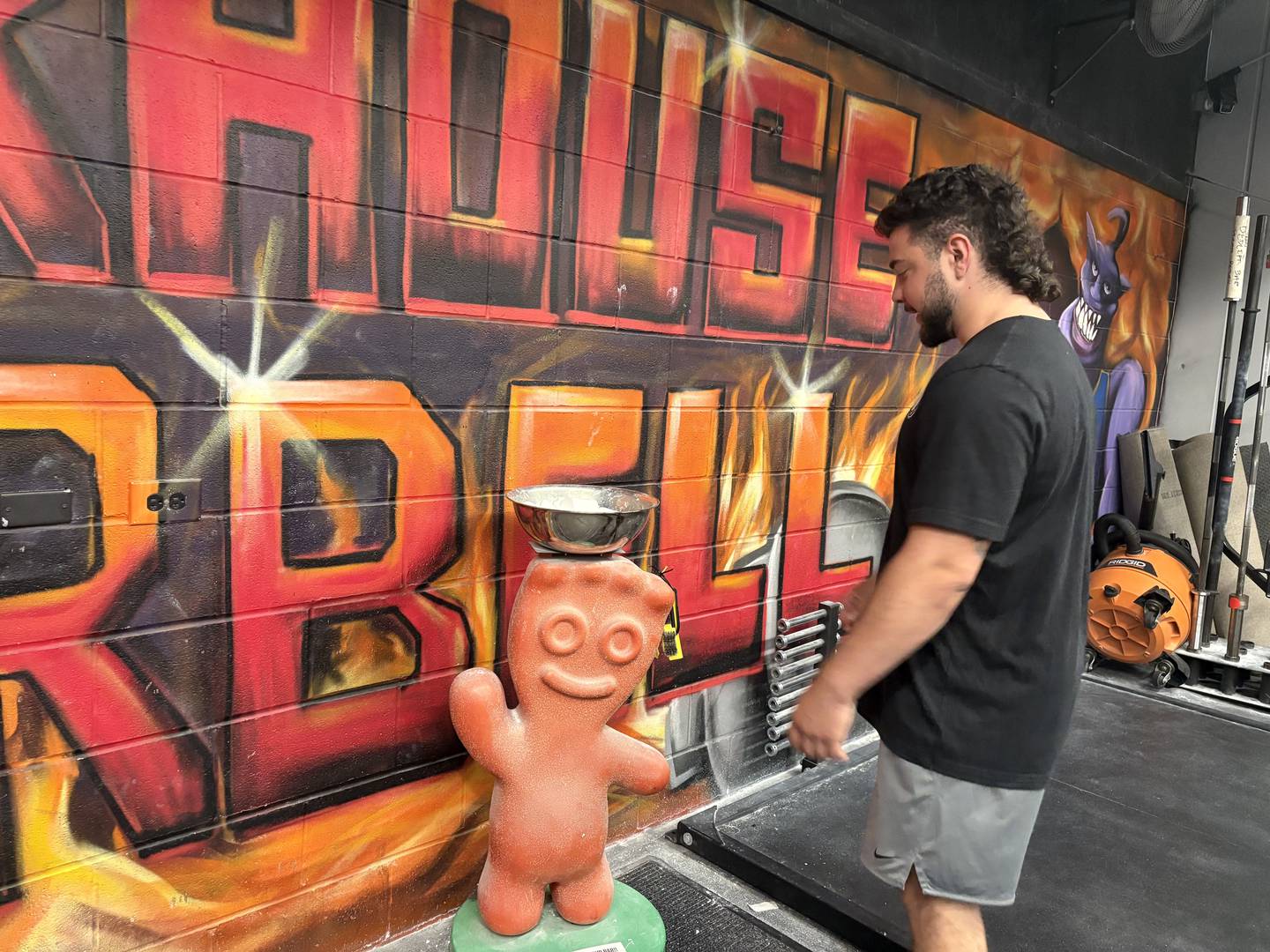 DJ Yatos looks at a chalk bowl at Warhouse Barbell in Huntley Sept. 3, 2025.