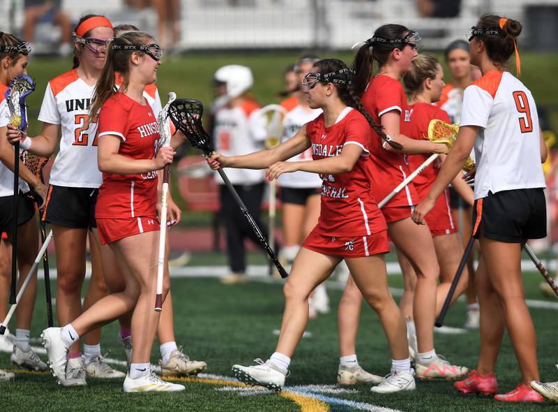 Hinsdale Central’s Grace Dolan, left, and Stefani Andrews celebrate their team’s victory over Crystal Lake Central Coop during the third-place game of the girls lacrosse state finals at Hinsdale Central High School on Saturday, June 7, 2025.