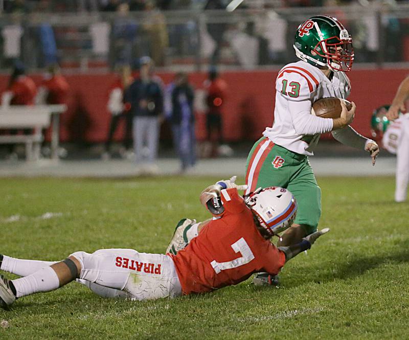 L-P's Brady Romagnoli (13) runs past Ottawa's Dillan Quantrano (7) on Friday, Oct. 7, 2022 at King Field in Ottawa.