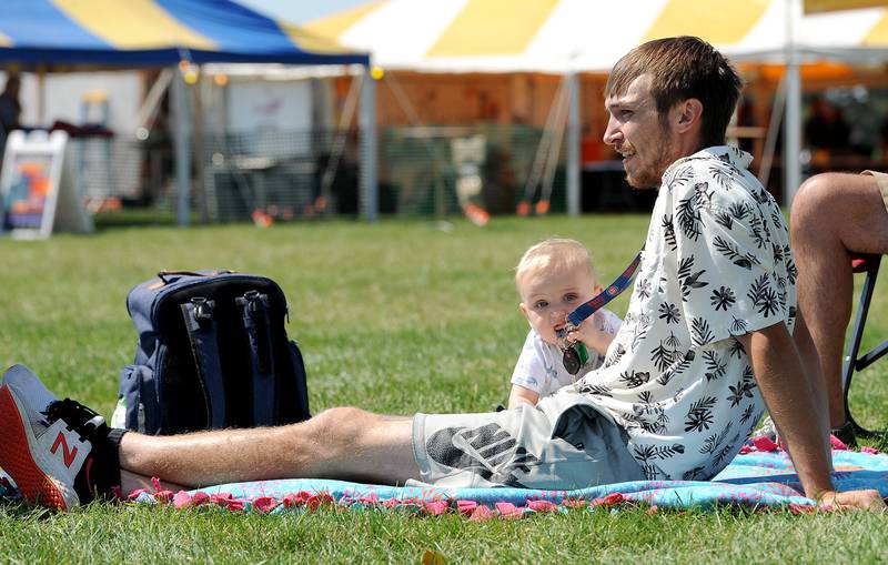 Nine-month-old George Redd of Aurora entertains himself with his dad, Brett's keys while the band American English entertained at Hometown Days on Sunday, Sept. 1, 2024, at Beecher Park in Yorkville.