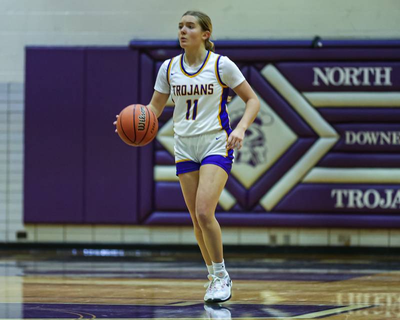 Downers Grove North's Abby Gross (11) advances the ball during girls basketball game between Downers Grove South at Downers Grove North. Dec 16, 2023.