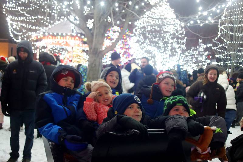 Children crowd into a small sleigh for a photo during the A Very Merry Huntley on Saturday, Dec. 6, 2025.