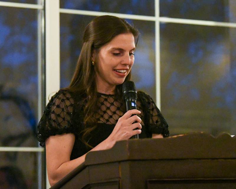 Brianna Wynne speaks about her grandfather Harrison Schneider during the St. Charles Area Chamber of Commerce Charlemagne Awards dinner on Friday May 1, 2026.