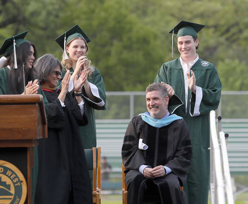 Principal Dr. Peter Monaghan who is retiring at the end of June is recognized for his years of service during the Glenbard West commencement ceremony Thursday May 18, 2023 on Duchon Field in Glen Ellyn.