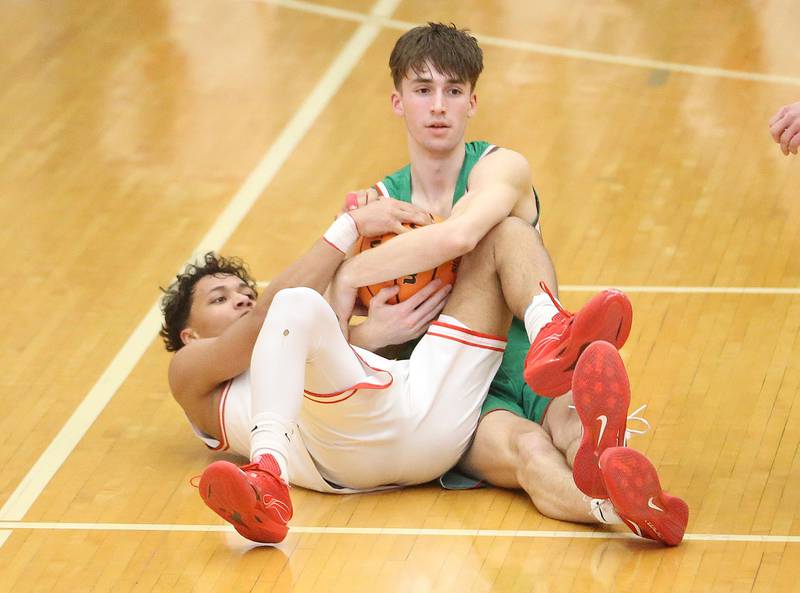 L-P's Wyatt Kilday forces a jump ball with Ottawa's Hezekiah Joachim on Friday, Feb. 6, 2026 in Kingman Gymnasium at Ottawa High School.