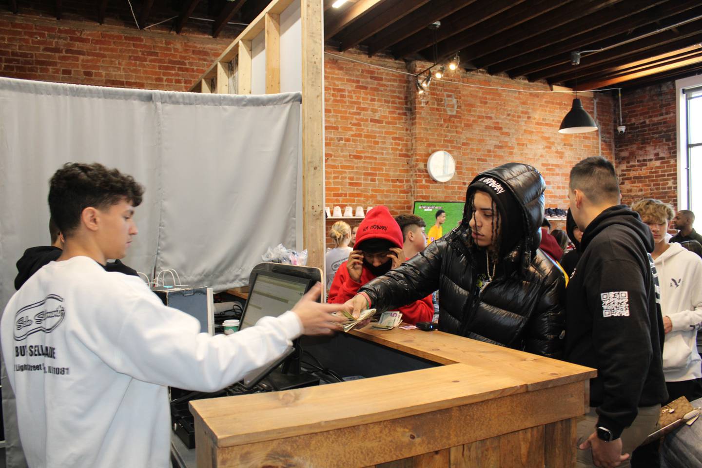 Alex Rangle (left) helps Isaiah Jimenez make purchases at the Sole Statement store in Sterling.