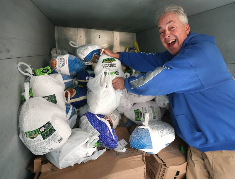 TD Ryan, host of the TD Ryan Unleashed podcast, adds another donated turkey to the pile during his Let’s Talk Turkey Thanksgiving food drive Friday, Nov. 21, 2025, at the Salvation Army food pantry in DeKalb.