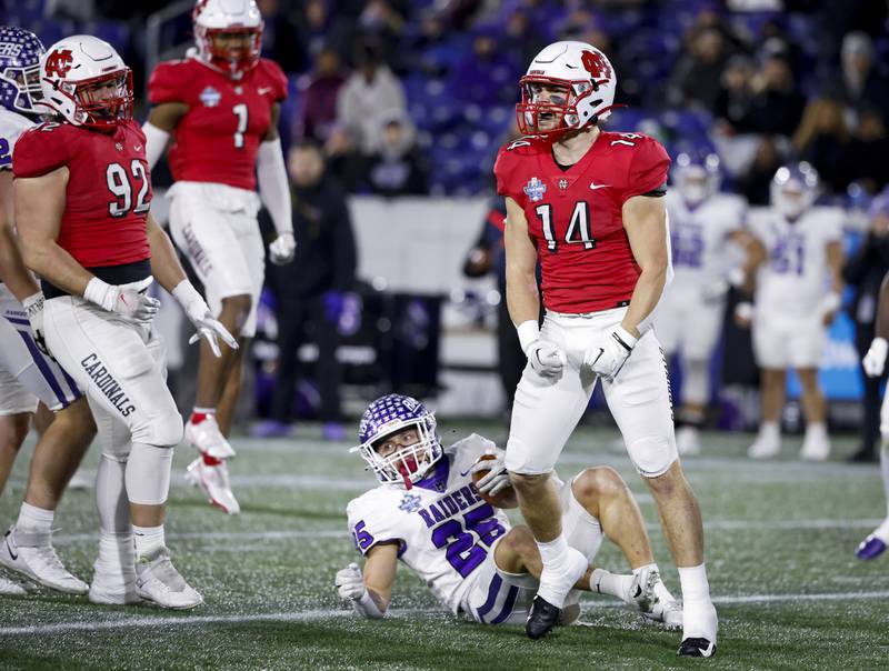 North Central's Sam Taviani (14), a Downers Grove North graduate, celebrates a stop during the Stagg Bowl win over Mount Union for the Division III National Championship on Dec. 16, 2022.
