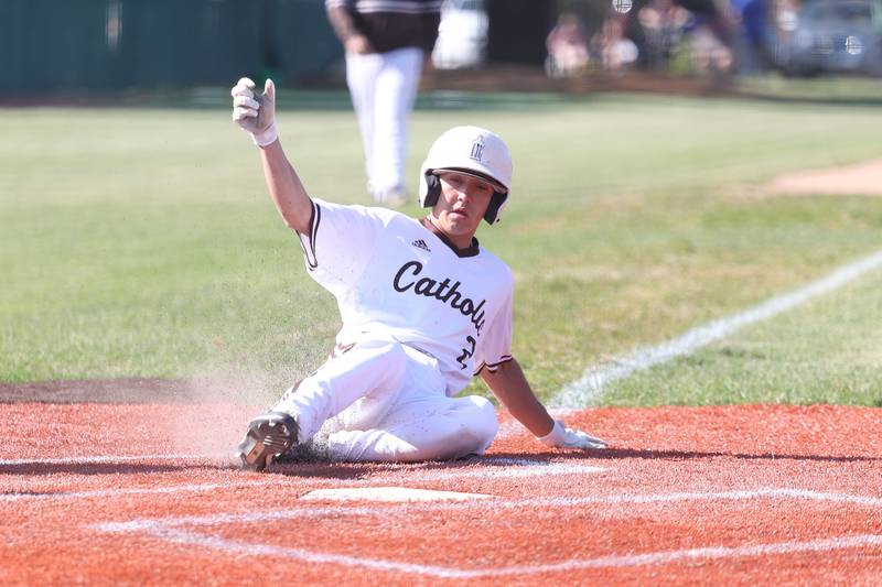 Joliet Catholic’s Tommy Kemp slides home uncontested on a wild pitch against Leo in the Class 2A sectional semifinal on Thursday, May 25, 2023, in Joliet.