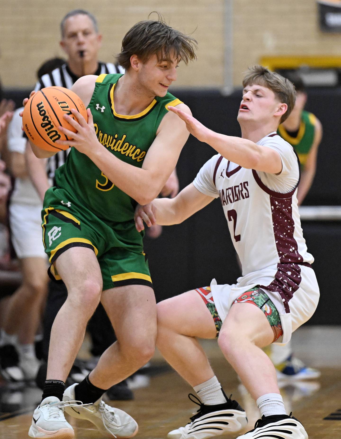 Providence's Luke Rost, left, looks for an open teammate while under defensive pressure from Wheaton Academy's Tyler Anderson during the Class 3A Hinsdale South boys basketball sectional semifinal in Darien Wednesday.