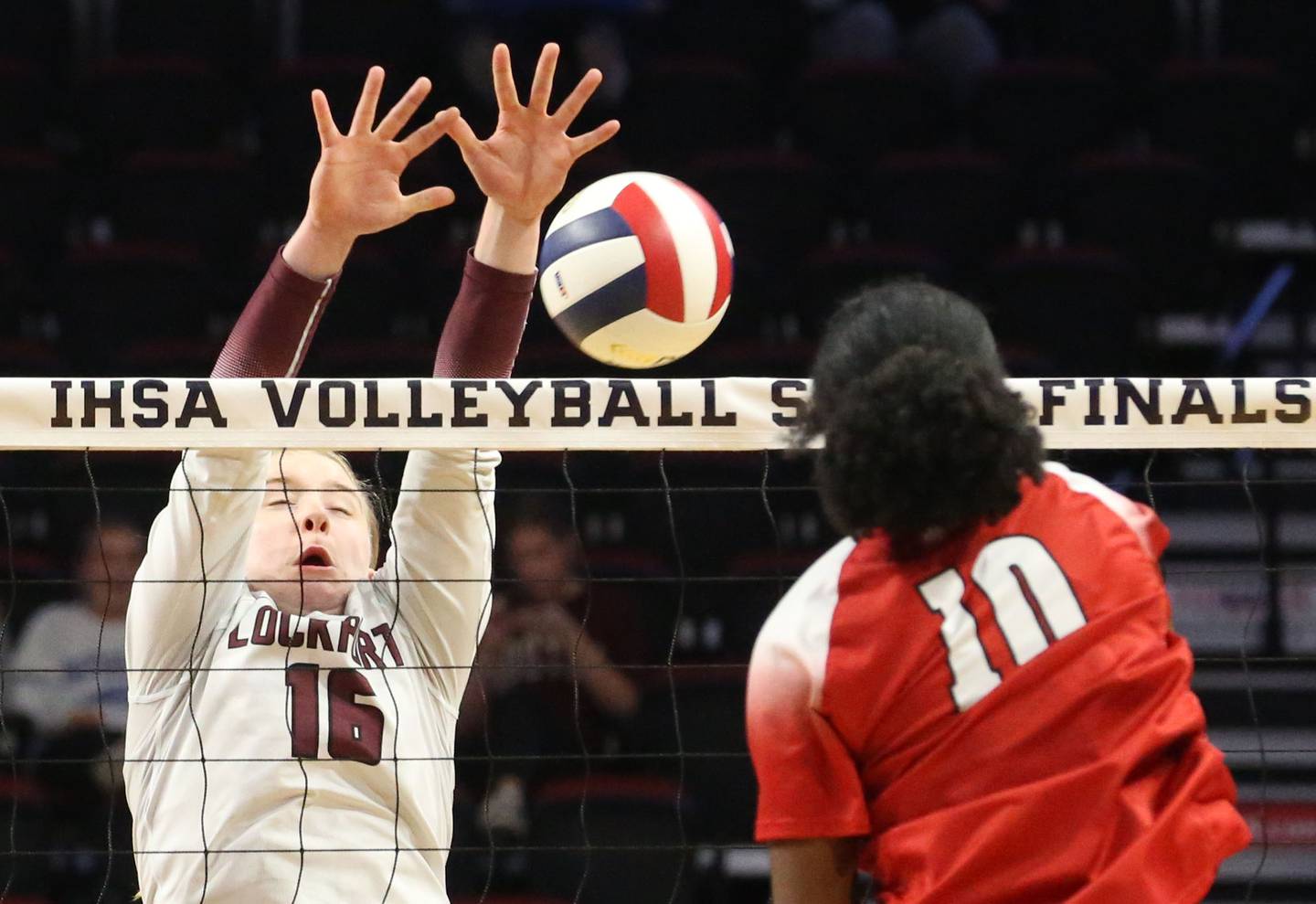 Marist's Savanah Weathers sends a kill past Lockport's Quinn Highan during the Class 4A State semifinal game on Friday, Nov. 15, 2024 at CEFCU Arena in Normal.