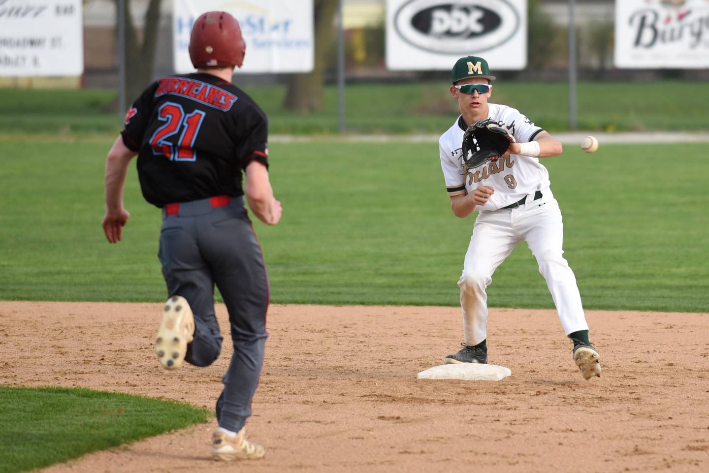 Bishop McNamara's Nick Pignatiello, right, fields a throw at second base ahead of Marian Central's Conor Brandt during a game at Bishop McNamara Friday, April 17, 2026.