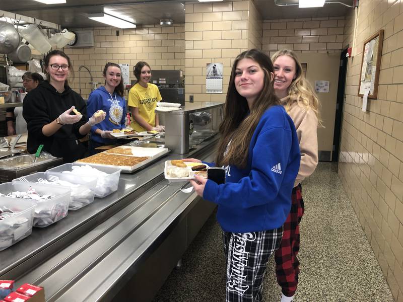 West Carroll FFA officers, Taylor Schmoll, Faith Hovious and Tori Moshure serving Shelby Williams and McKenzie Lindsay at the West Carroll FFA Breakfast