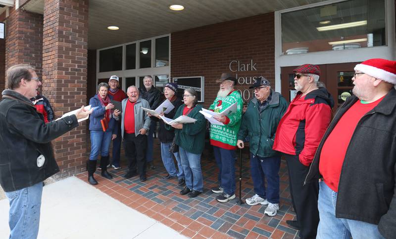 Members of the Covered Bridge Barbershop Chorus sing Christmas Carols during the annual Christmas Walk on Saturday, Nov. 22, 2025 outside the Clark House in Princeton.