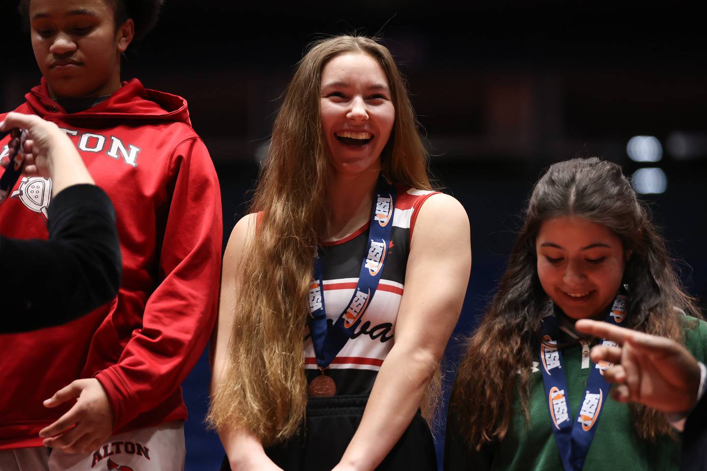 Ottawa’s Sara Meyer has a laugh after excepting her 3rd place medal in the 140 pound class at Grossinger Motor Arena in Bloomington. Saturday, Feb. 26, 2022, in Champaign.