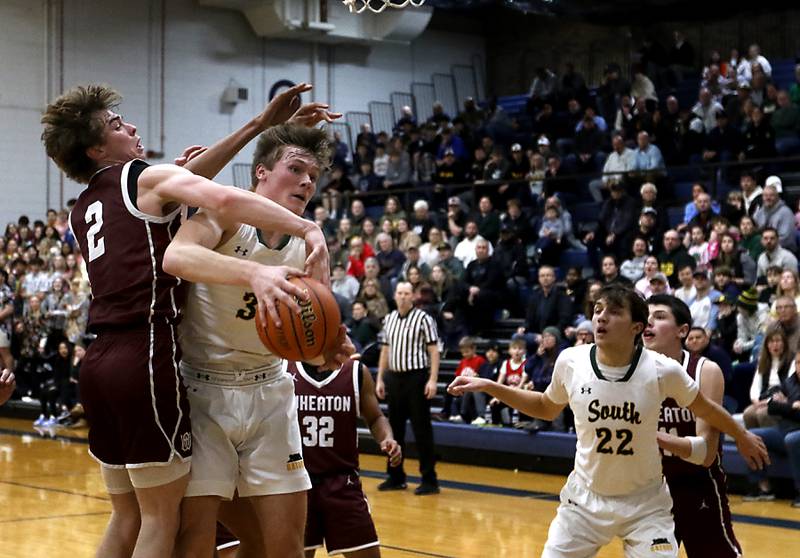 Crystal Lake South's Colton Hess tries to grab a rebound in front of Wheaton Academy's Tyler Smith during the IHSA Class 3A Cary-Grove Boys Basketball Regional Championship game on Friday, Feb. 23, 2024 at Cary-Grove High School.