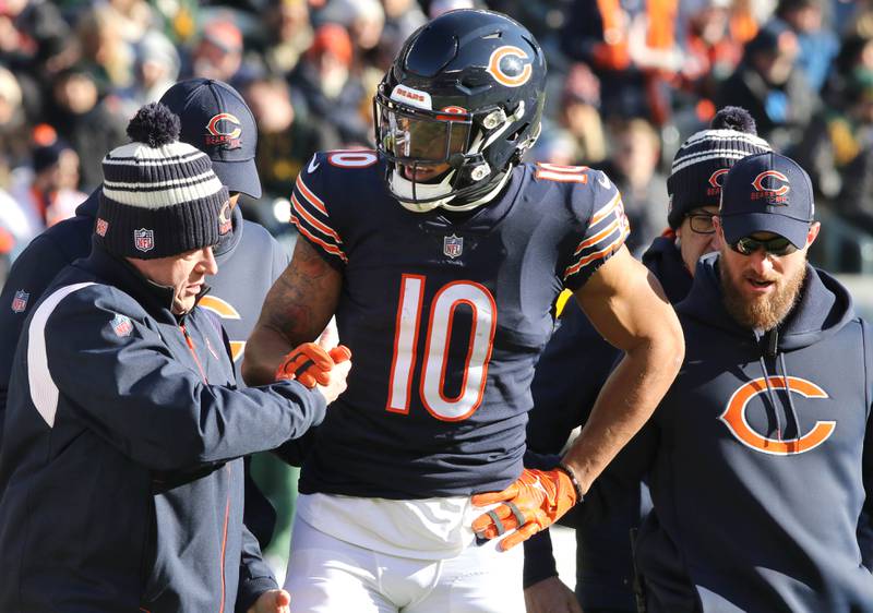 Chicago Bears wide receiver Chase Claypool is helped off the field after an injury in the first half of their game against the Green Bay Packers Sunday, Dec. 4, 2022, at Soldier Field in Chicago.