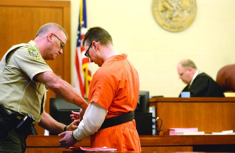 An Ogle County correctional officer secures handcuffs on Duane Meyer following his motion hearing on Thursday, May 4, 2023.