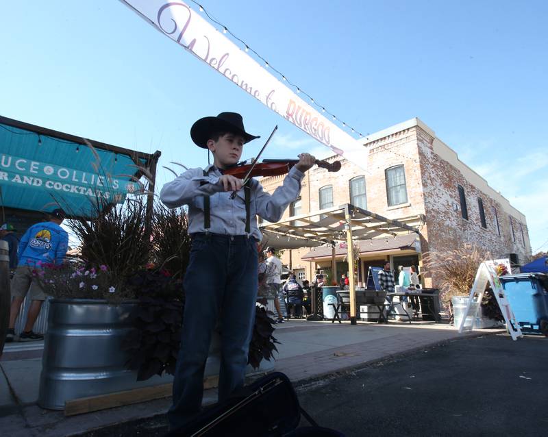 Grant Passwater of Ottawa performs on his violin during the 54th annual Burgoo on Sunday, Oct. 13, 2024 downtown Utica.