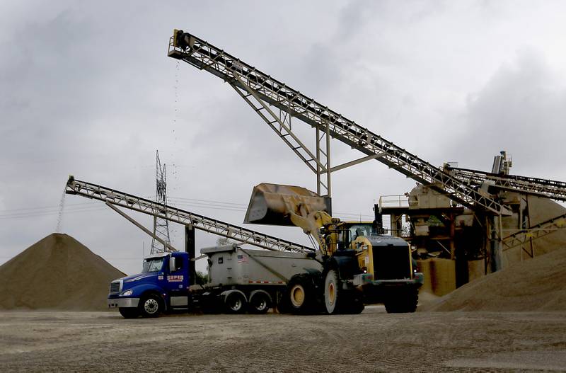 Gravel is loaded into a truck at the Super Aggregates Marengo Lakes mine during the McHenry County Sand and Gravel Mining Tour on Thursday, Oct. 12, 2023. The tour brought McHenry County board members, township and village officials on a four hour trip to visit operating mines on Route 23 in Marengo and to former sites now reclaimed for housing, recreation in Algonquin and Cary.