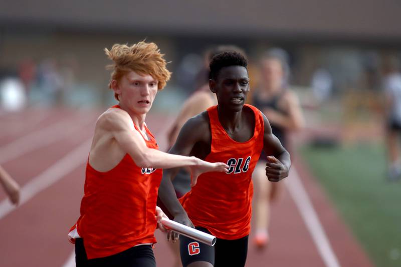 Crystal Lake Central’s Oliver Lavaty hands the baton to Reed Mihelich, left,  in the 3200-meter relay in Fox Valley Conference boys track and field meet action at Huntley High School in Huntley on Thursday, May 15, 2025.