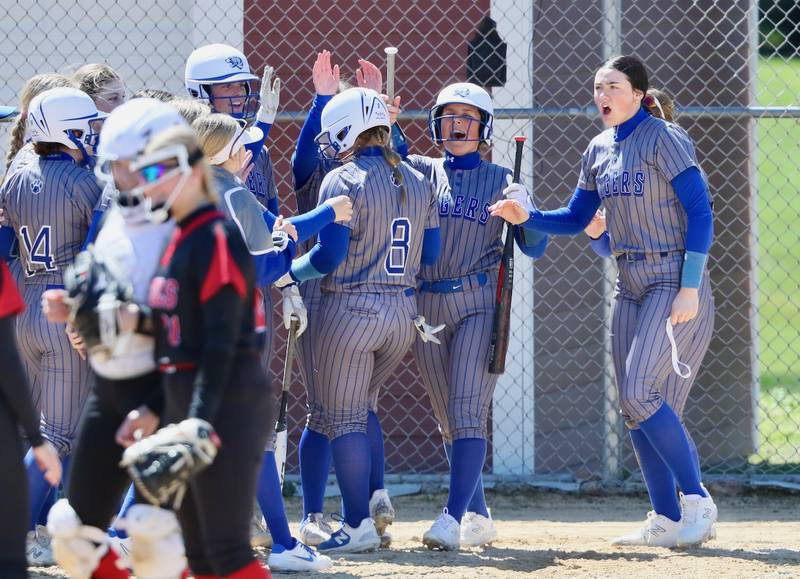 Princeton's Avah Oertel is greeted by all her friends in blue after her home run Saturday at Hall.