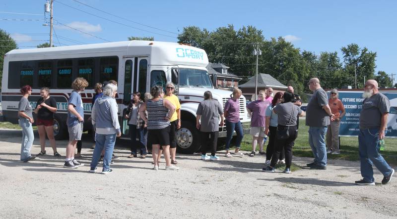 Volunteers and community members mingle near the future home of the Second Story Teen Center will be built at the intersection of Crown Street and South Main Street on Wednesday, Aug. 16, 2023 in Princeton.