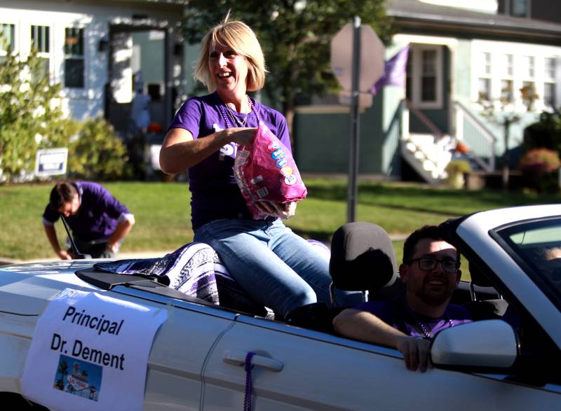Downers Grove North Principal Courtney Dement throws candy on Friday, Oct. 18, 2024 during the school’s annual homecoming parade.
