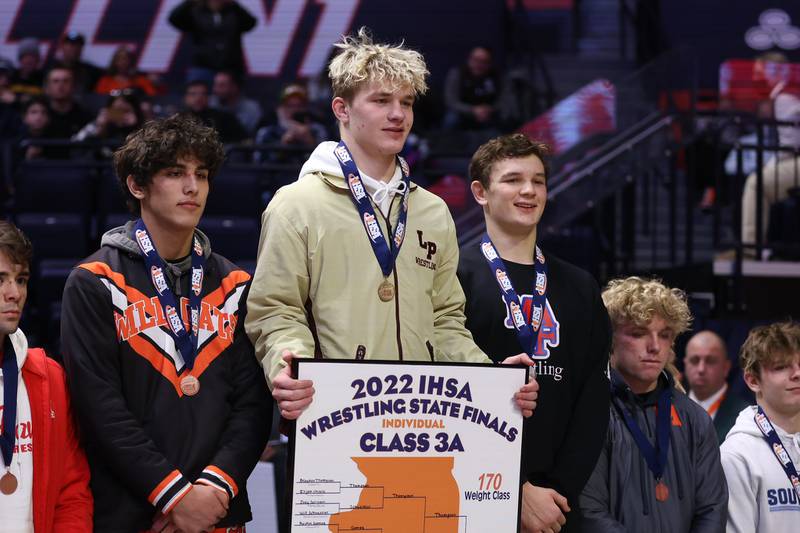 Lockport’s Brayden Thompson takes the podium as the Class 3A 170lb. champion at State Farm Center in Champaign. Saturday, Feb. 19, 2022, in Champaign.