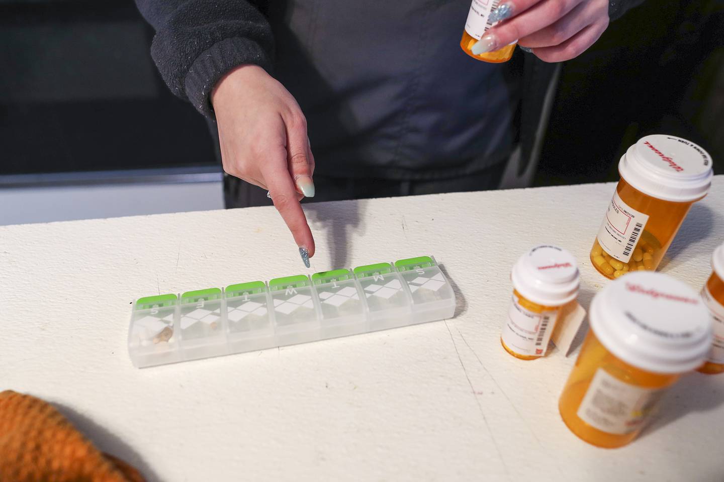 Marlene Lara prepares the weeks medication for one of the Will-Grundy Medical Clinic's clients on Friday, Feb. 12, 2021, in Joliet, Ill.