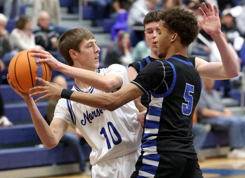 Newark's Dylan Kulbartz looks to pass around Hinckley-Big Rock's Emeka Ezuma Friday, Feb. 6, 2026, during their Little 10 Conference third place game at Somonauk High School.