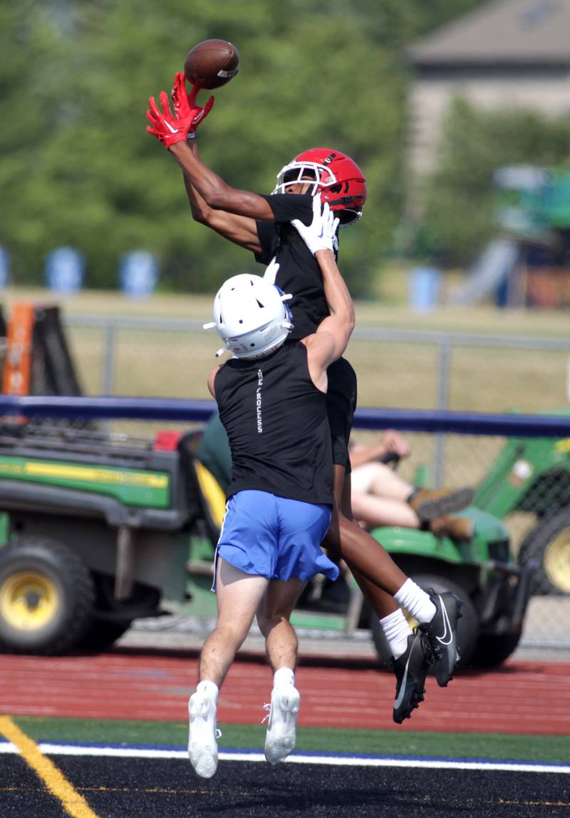 A Yorkville player leaps for the catch during a 7-on-7 football game against St. Charles North at St. Charles North on Thursday, June 22, 2023.
