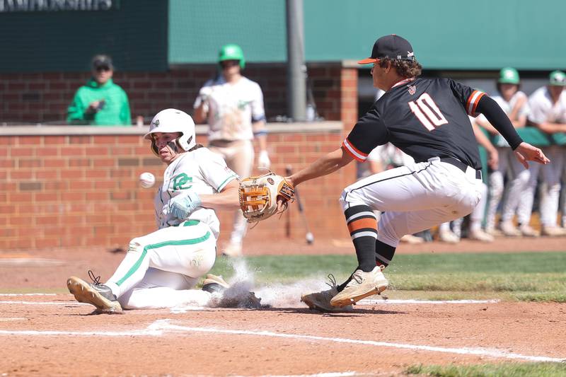 Providence’s Cooper Eggert beats the throw to the plate to score on a wild pitch against Lincoln-Way West on Saturday, May 11, 2024 in New Lenox.