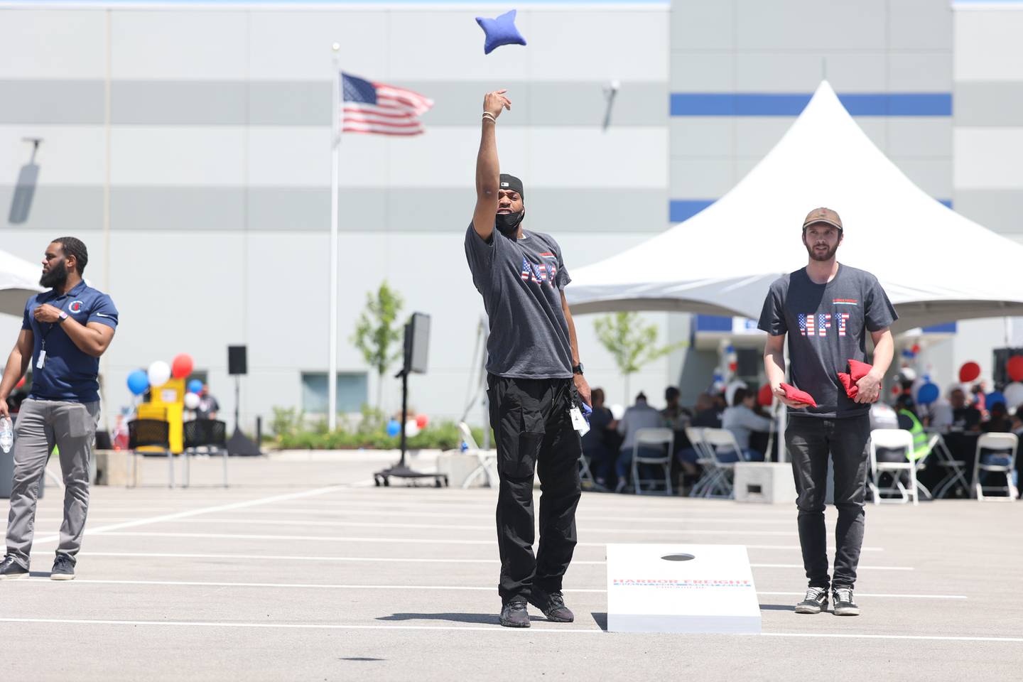 Harbor Freight equipment operator Kendall Coleman tosses bags with co-workers at a ribbon cutting ceremony. Harbor Freight opened a new 1.6 million square-foot distribution center in Joliet that is expected to bring 800 new jobs to the area. Thursday, June 9, 2022 in Joliet.