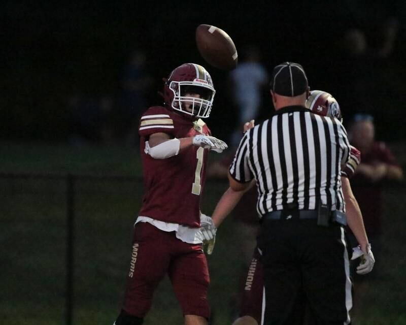 Morris Aj Zweeres (1) hands the ball to the ref after a touchdown reception during football game between Joliet West at Morris.  Sept 1, 2023.