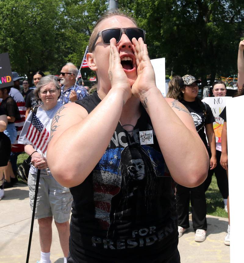 Maddie Boylin, from Genoa, yells at a supporter of President Donald Trump Saturday, June 14, 2025, during a No Kings rally along Sycamore Road at Hopkins Park in DeKalb. The group was protesting the policies of President Donald Trump and his administration.