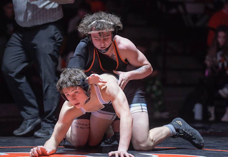 St. Charles East's Jayden Colon, top, and Marian Central's Josh Gowronski wrestle at 150 pounds during a match in St. Charles on Wednesday, December 20, 2023.