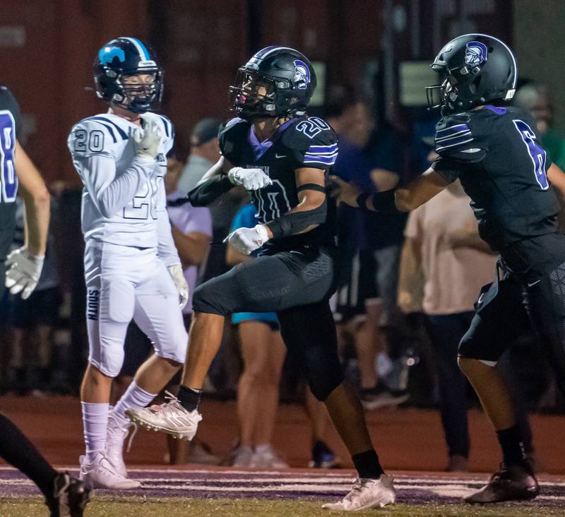 Downers Grove North's Noah Battle (20) celebrates after scoring a touchdown against Downers Grove South during a football game at Downers Grove North High School on Friday, Sep 9, 2022.